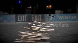 Young figure skater spins with holiday lights creating a magical effect.