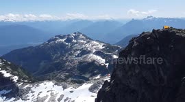 Slackliner enjoys summer highlining between mountain peaks in Whistler, Canada