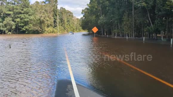 Coastal flooding in Southport North Carolina leaves truck submerged in water