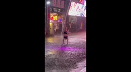 Come rain or shine! Dancer performs in pouring rain on Pattaya red light strip