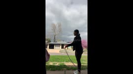 Child helps neighbor with trash in Oklahoma City