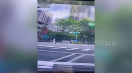 Uprooted tree falls on car during storm in Taiwan