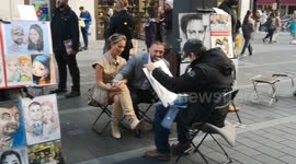 Conor McGregor is spotted having fun in London's Leicester Square as he has a caricature drawn of him by artists