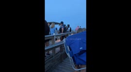 Woman falls off boardwalk railing behind officer in Avalon, New Jersey