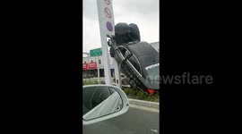 Car collides with traffic light pole after avoiding pedestrian at crossing in China