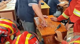 Chinese student swiftly rescued by firefighters after his finger stuck in desk hole