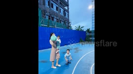 Mum Holding Baby Sinks Impressive One-Handed Three-Point Shot