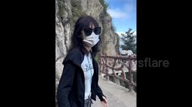 Tourist's £850 phone slips from pocket and plummets off cliff whilst taking scenic video in China