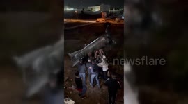 Palestinians Cheer for the remains of the Iranian missile that fell near the city of Ramallah
