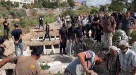 Local Imam and citizens bury the body of a deceased fellow at the funeral, Sidon, Lebanon