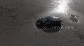 You can't park there! Drone footage of car stuck in thick mud at Cleethorpes beach