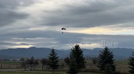 Motorized Para Glider flying in Montana with the Mission Mountains behind him.