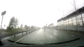 Truck Skids On The Road, Knocks Down Gas Station Billboard And Ends Up On The Crash Barrier