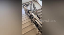 Hundreds of socks put out to dry on building's stairwell handrail