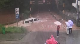 Minibus swept away after driving on flooded road