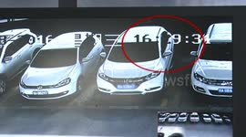 Man exchanges tyre on car in Chinese car park