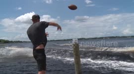 Man catches American football while doing a backflip on a wakeboard