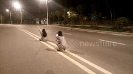 Girls take selfies in the middle of road in China