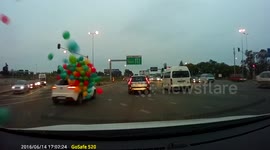 Dozens of balloons fly off car on busy road