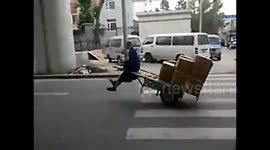Man cleverly balances handcart for effortless ride