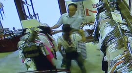 Couple cooperates to steal clothes in clothing shop