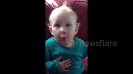 Baby's reactionto Cheerio is priceless
