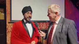 Magic Singh shows incredible phone trick to Andrew Eborn at The Magic Circle's Grand Night Of Magic & Stage Magician of The Year