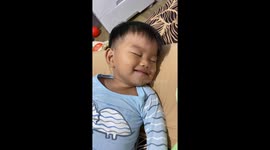 Adorable toddler wins hearts by laughing cutely in his sleep