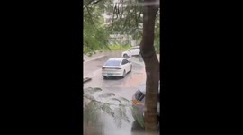 Passing students help to release car stuck on steps