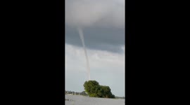 Tall Waterspout Descends Into River Water