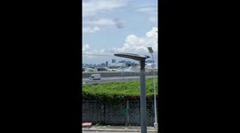 Fumes pour from plane's engine while parked at airport