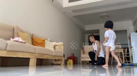 Chinese toddler learns breakdancing with dad at home