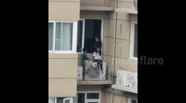 Argument between couple leads to wife placing young children on air-con unit on 23rd floor