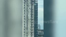 Workers hurl metal from 53-storey abandoned building in Pattaya