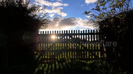 Sunset timelapse through a gate to a field in the Derbyshire countryside. 4K