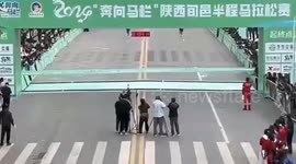 Fake runner tries to beat winner to finishing line