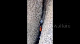 Heroic hiker climbs into narrow mountain crevice to rescue trapped goat