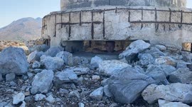 WW2 Italian observation post with what appears bomb to be large bomb craters and destroyed artillery positions