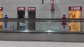 Passengers make rowing boat on airport travellator