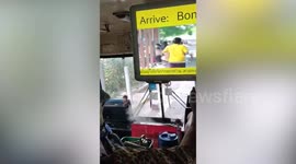 Smoke comes out of dashboard of moving bus in front of driver