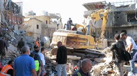 Lebanon: Rescuers at work after an Israeli strike demolished buikdings in Beirut