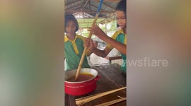 Students weave coloured bamboo strips into sustainable phone cases at school