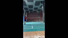 Badminton player celebrates rally victory, accidentally gets racket stuck in ceiling