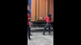 Box of drinks hits woman while opening container in South Sulawesi, Indonesia