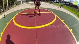 Sheriff's Deputy takes time out to play basketball with local children