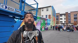 Artist Andre Traneer finished up the final touches of his mural on a building in Allentown, PA