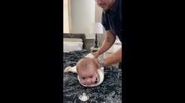 Swaddled Spy Baby Lowered To Binky