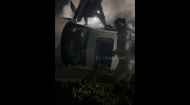 Chinese man rushes to help after car flips over on busy road