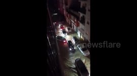 Spain: Cars Navigate Flooded Road In Paiporta