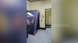 Resident strikes mattress with kung-fu flying kicks to force it through door